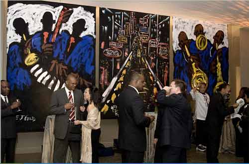 Guests at Jazz Heritage Center's Grand Opening take in Jazz Art � works by E.J. Gold including San Francisco Jazz Joints in the center of the photo